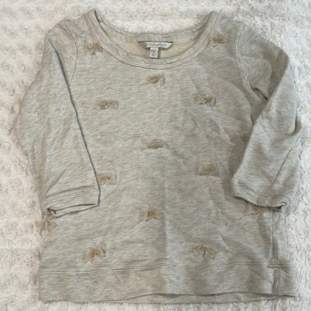 M Lauren Conrad sweater. 3/4 length sleeves. Cute ribbon bows on the front.